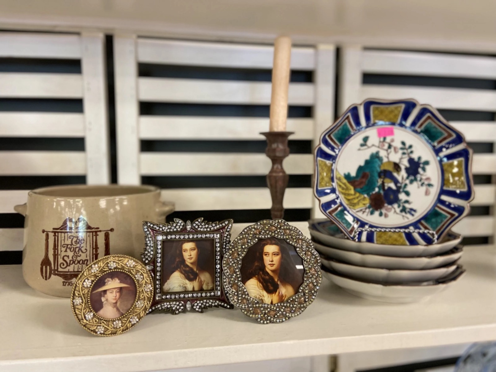 Donated housewares and vintage finds on the shelf at Redemption Thrift